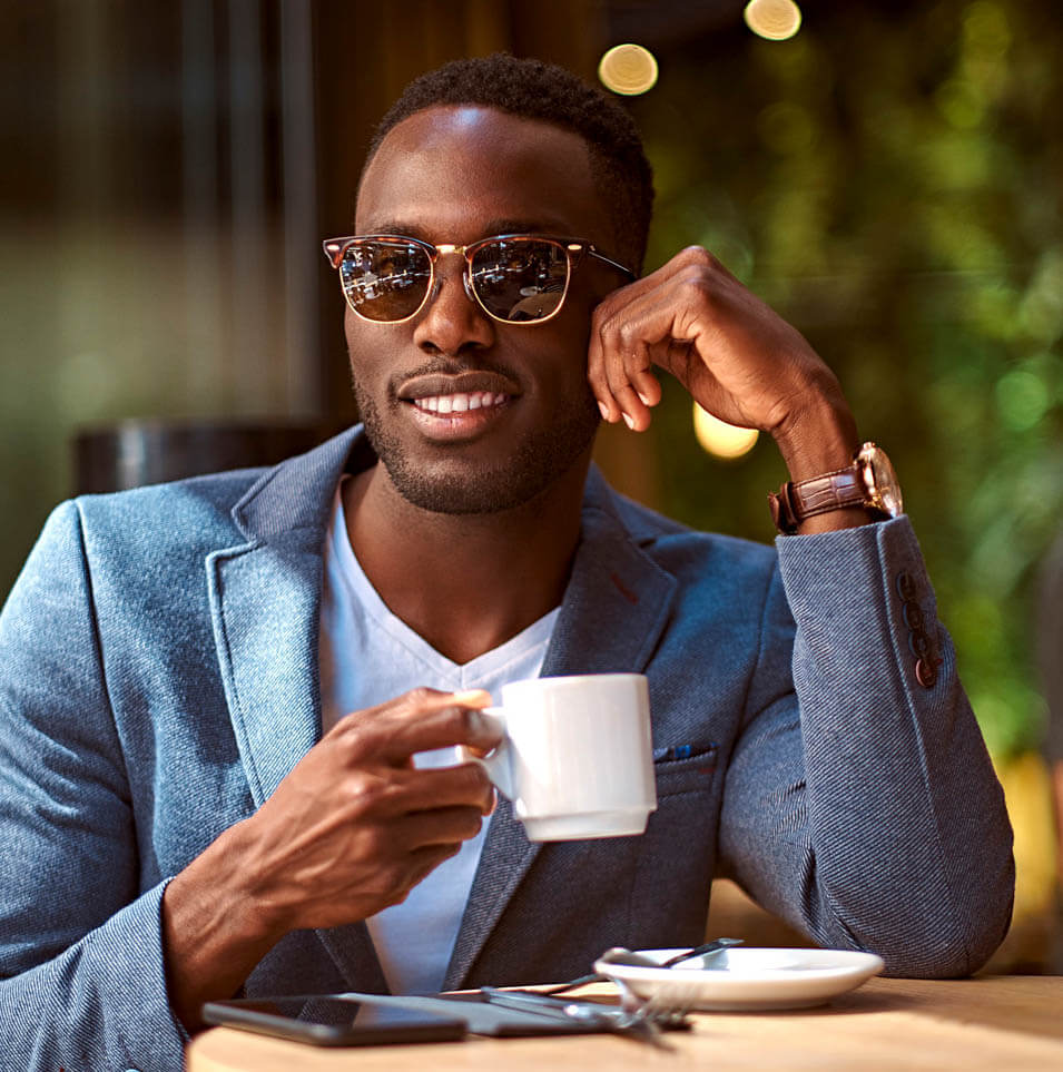 man in glasses drinking coffee