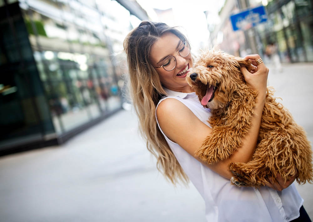 woman holding her dog